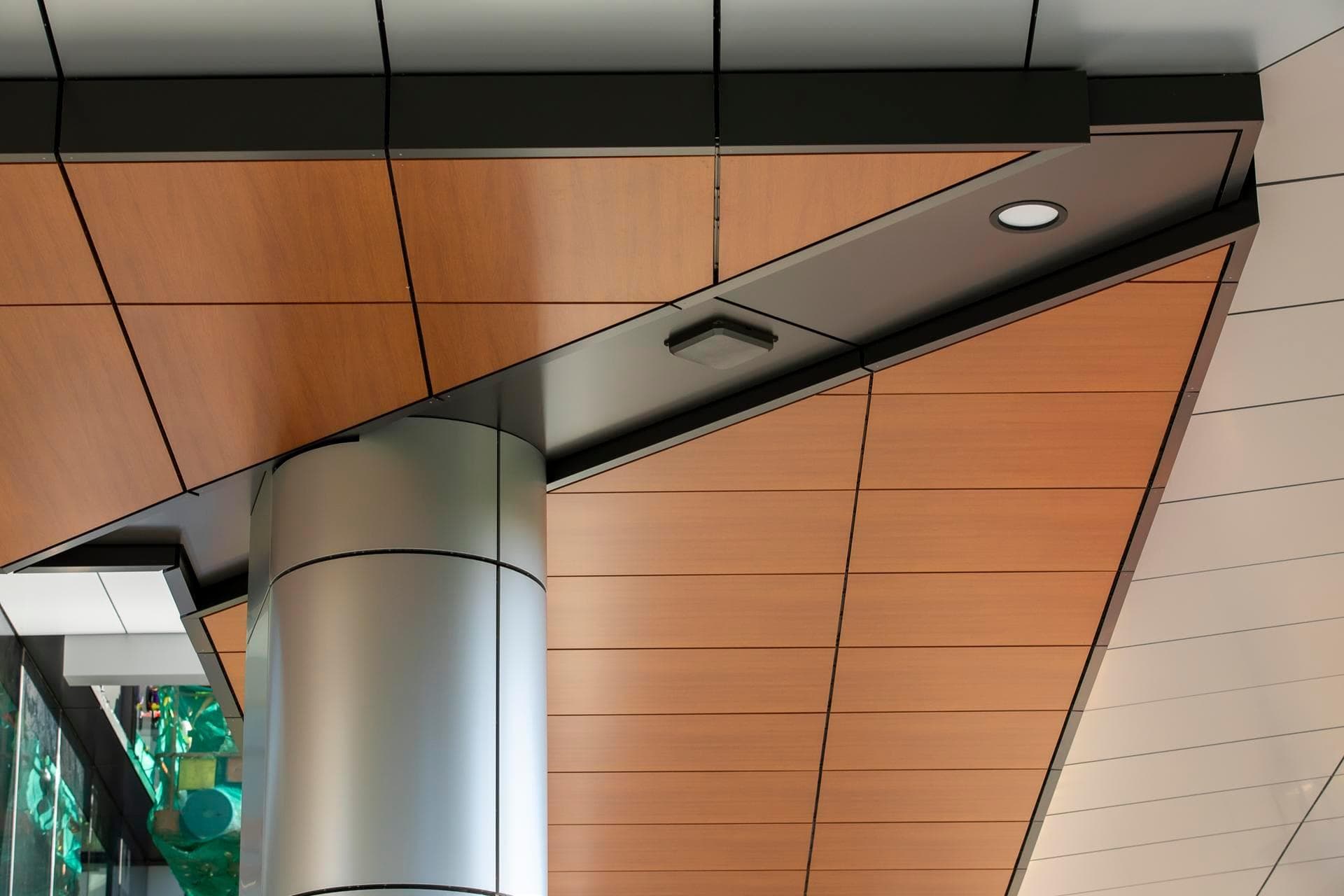 Interior soffit view at the Charles Perkins Centre with Alpolic NC woodgrain panels and cylindrical aluminium column.