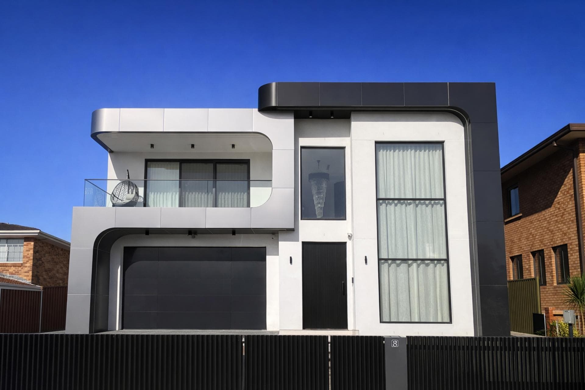 Curved residential façade featuring ALPOLIC™/fr in Sparkling Black and Dark Grey Metallic