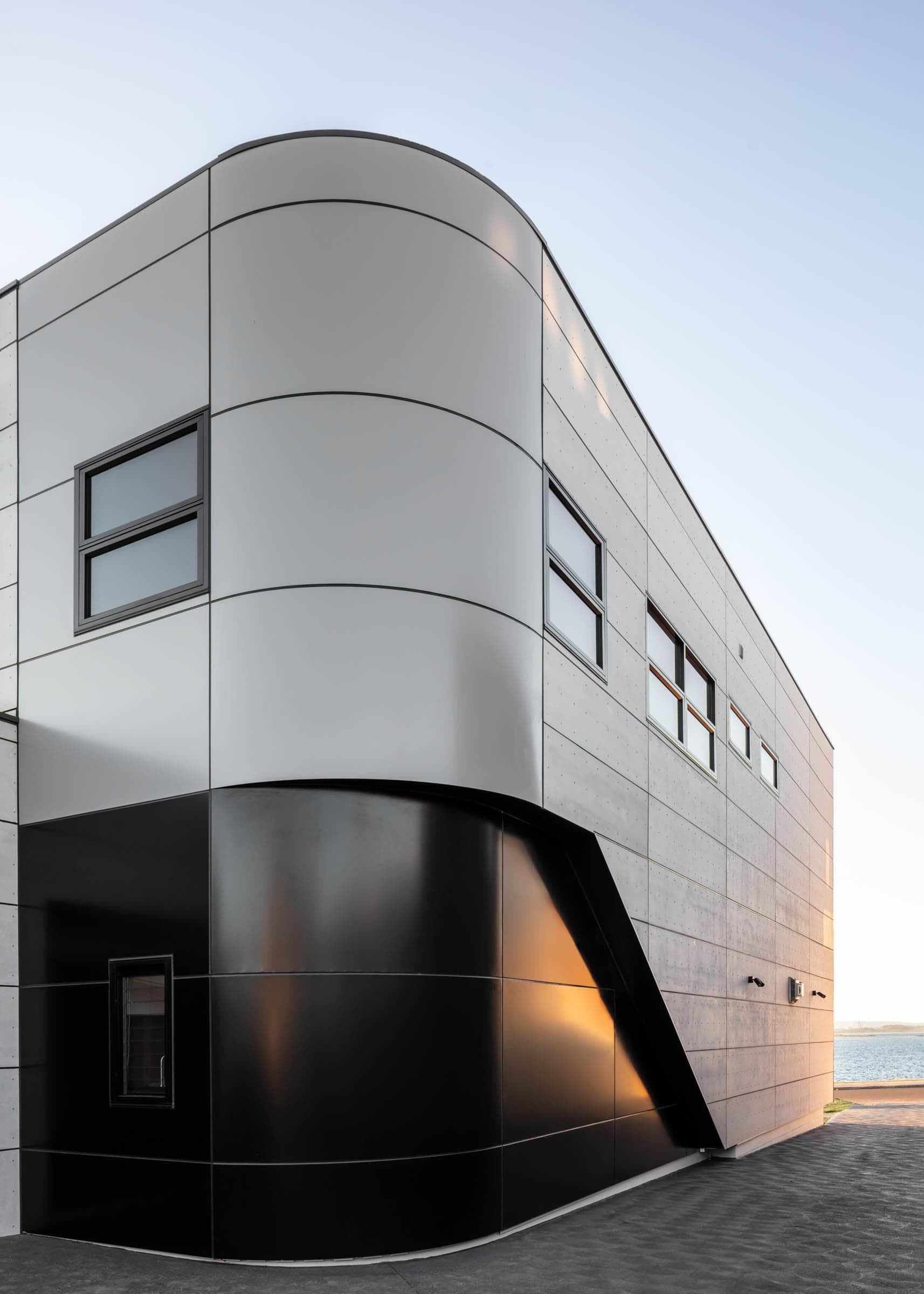 Curved wall detail with ALPOLIC™/fr Monotone Slate panels catching coastal light