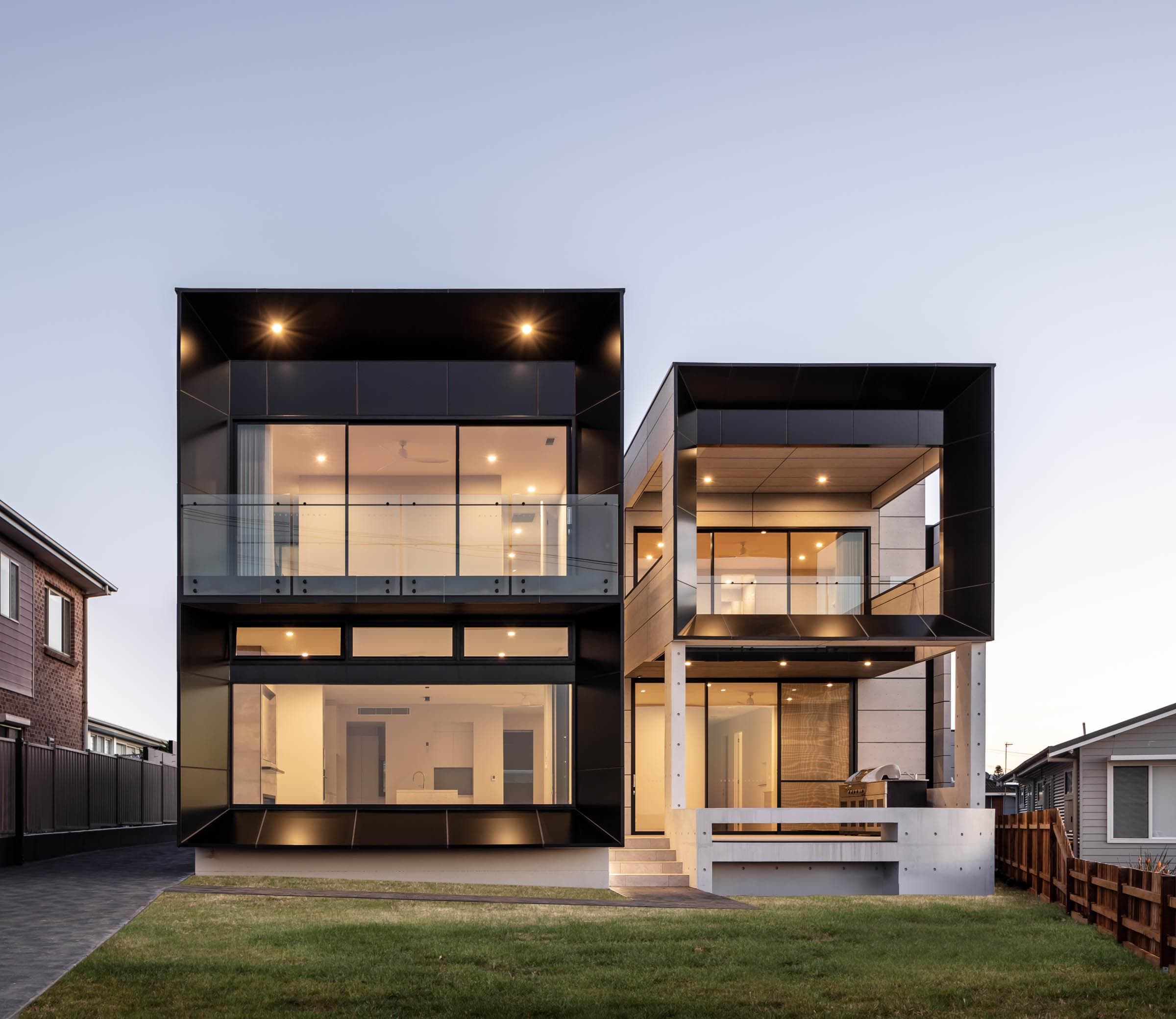 Evening view of The Icon residence with warm lighting on ALPOLIC™/fr Monotone Slate panels